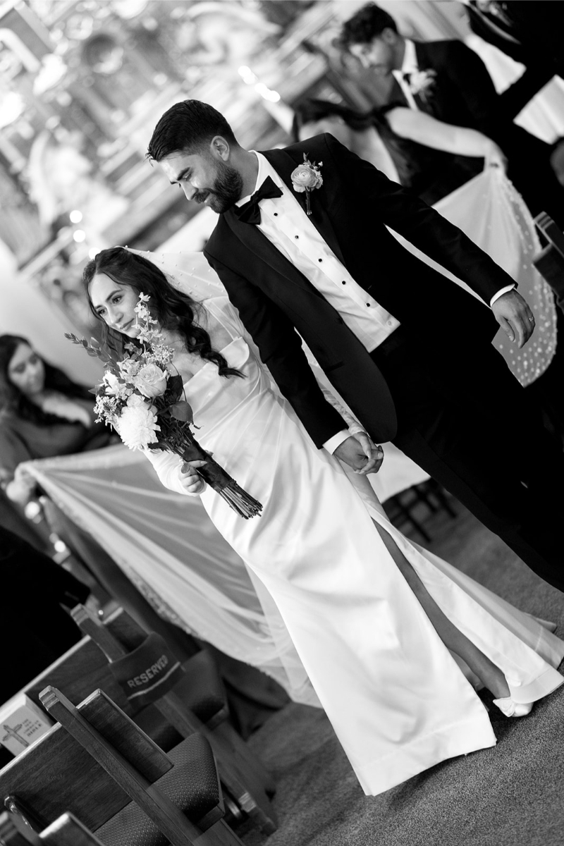 Black and white photo of New Mexico wedding couple exiting their ceremony. 