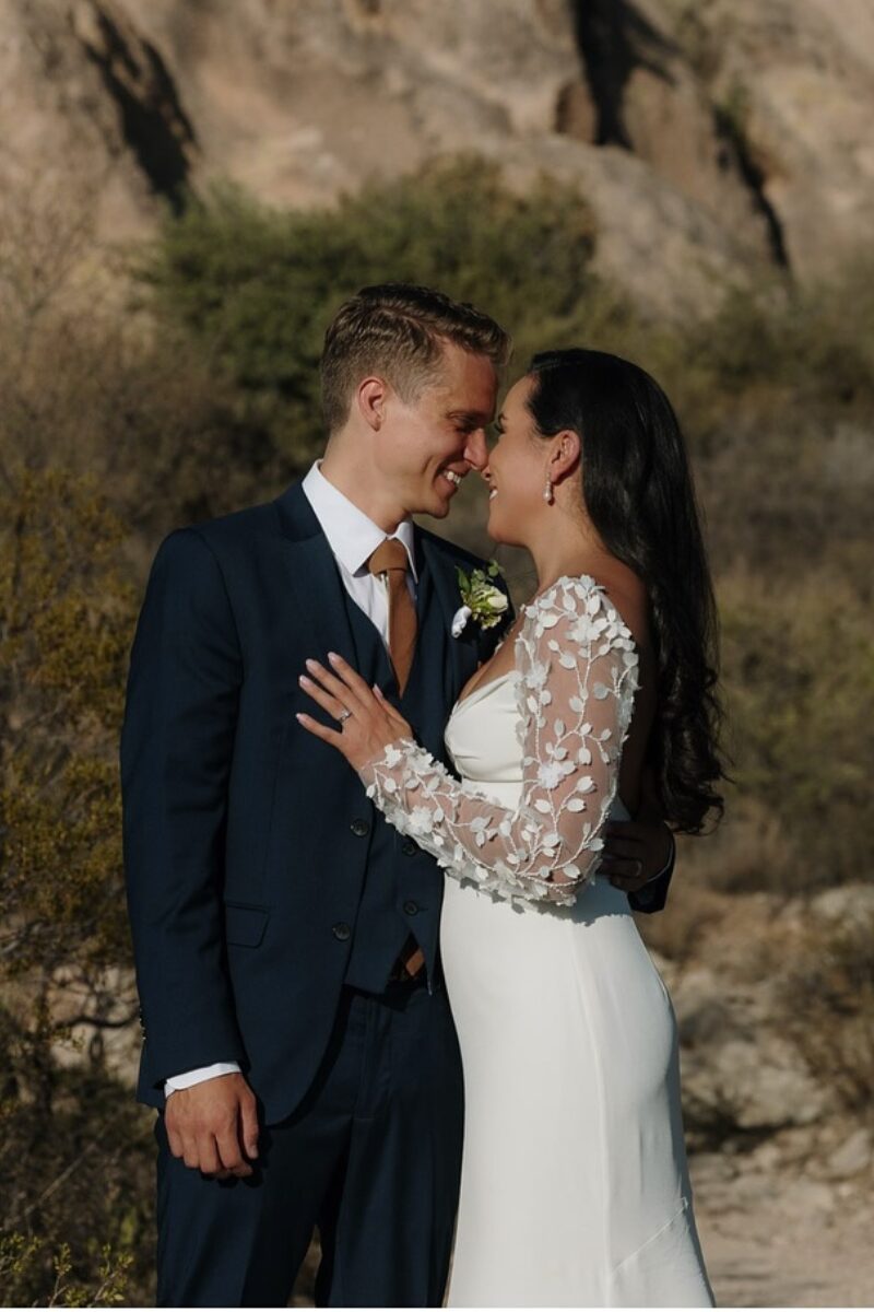Bride and groom share a close, smiling moment in the New Mexico desert, captured by their wedding day content creator, after they asked how long should you book a wedding day content creator.