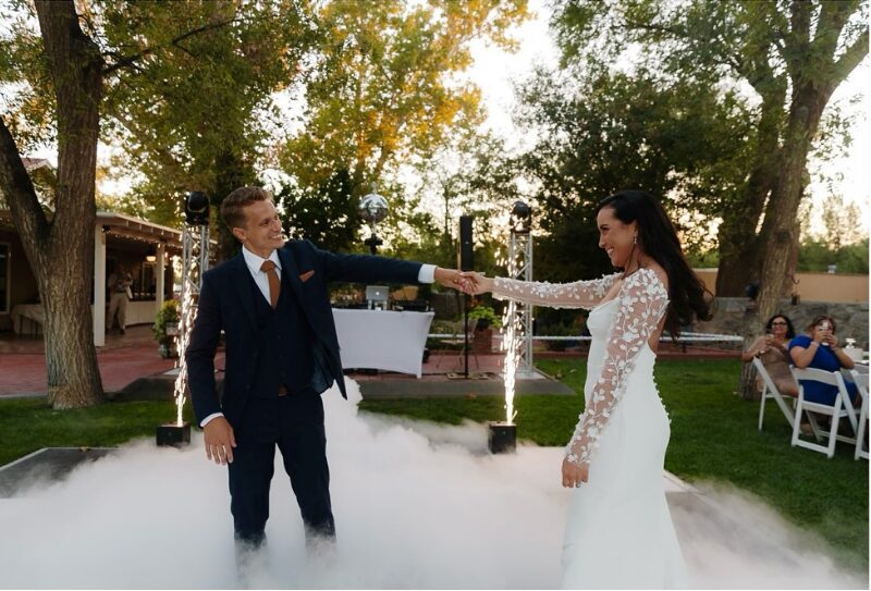 Bride and groom share their first dance surrounded by cold spark fountains, captured by their wedding day content creator.