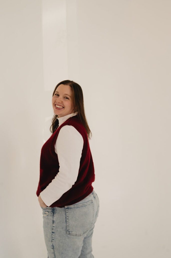 Sarah Roberson of Serendipity Records Content Co. stands against white wall for branding photos.
