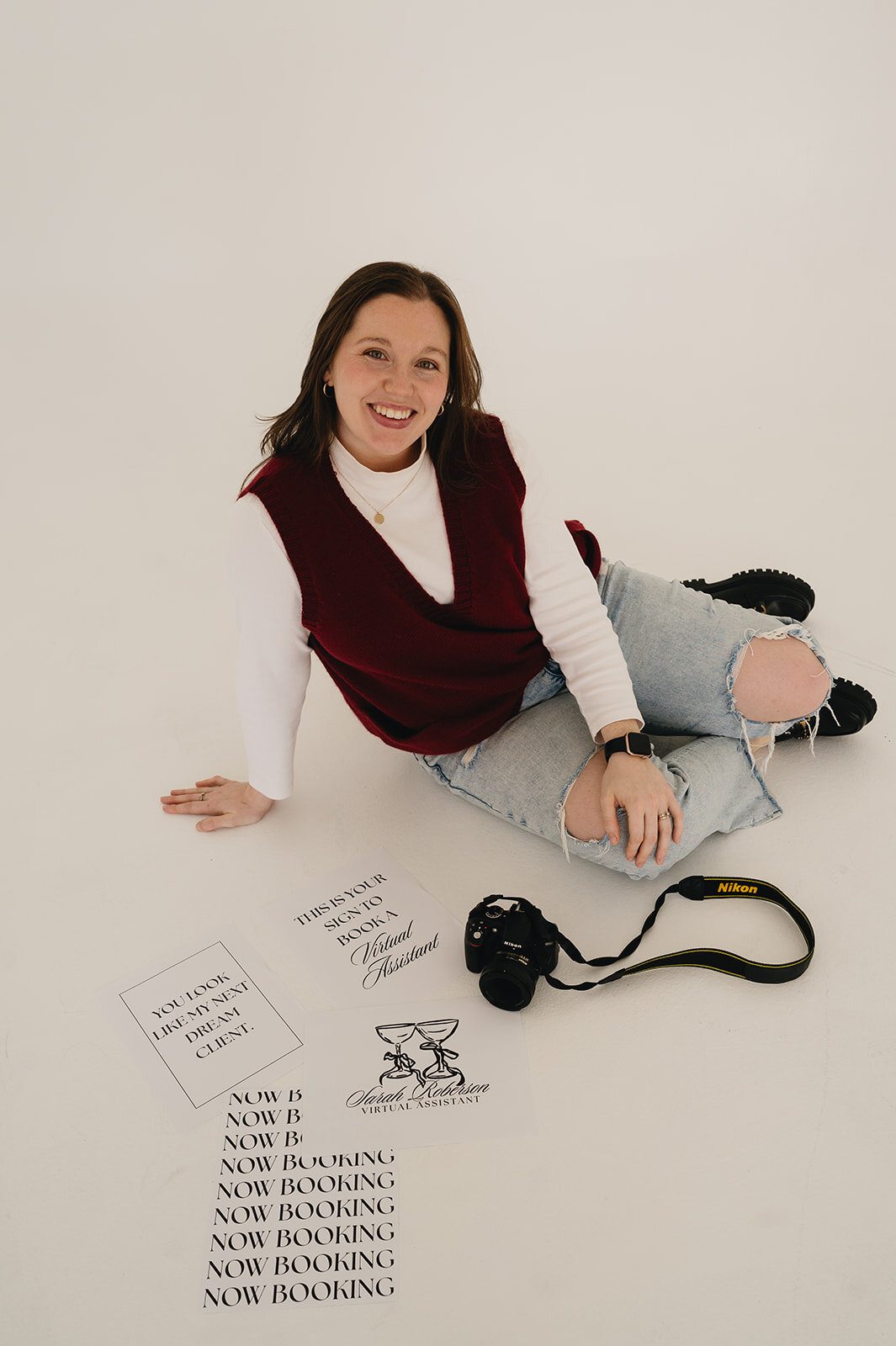 Sarah Roberson of Serendipity Records Content Co. sits on the ground for branding photos for her Las Cruces wedding content creator business.